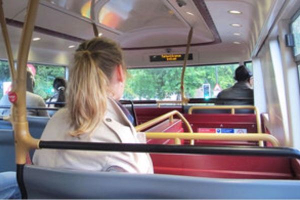 Female passenger sitting on a bus