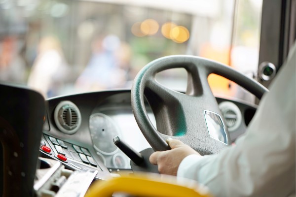 bus driver with hands on wheel
